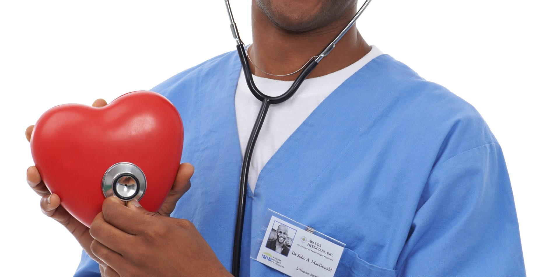 A doctor holding a heart prop in his hands